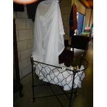 A late Victorian babies crib with drapes.