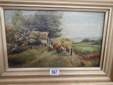 An early 20th century oil on canvas painting featuring a hay cart, 54 x 39 cm.