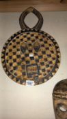 A West African tribal mask (flat round face)