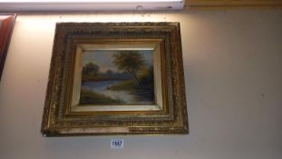 A gilt framed late 19th century/early 20th river scene oil on canvas signed but indistinct, some