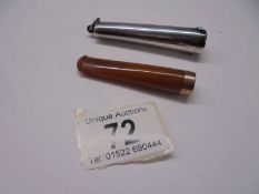 A silver cased amber cheroot holder with gold band, case 12 grams.