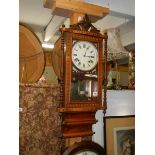 An early 20th century mahogany inlaid wall clock in working order.