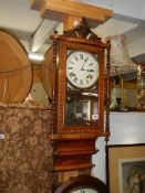 An early 20th century mahogany inlaid wall clock in working order.