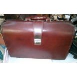 A vintage brown leather suitcase.