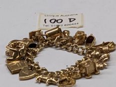 A 9ct gold charm bracelet with 15 charms, in good condition, 41 grams.