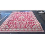 A large Middle Eastern style red floral pattern rug - 368cm x 275cm (COLLECT ONLY)