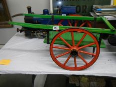 A toy wooden 2 wheel hay cart.