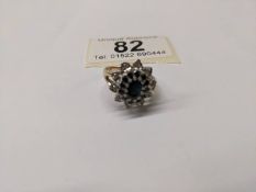 A diamond and sapphire cluster ring in 9ct gold, size M, 3.8 grams.