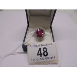 A 6.5 carat oval ruby platinum and diamond ring, size N half, 8 grams.