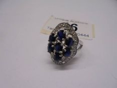 A large white gold sapphire and diamond ring, size M half, 5.6 grams.