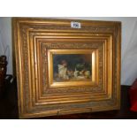 A gilt framed painting on wood.