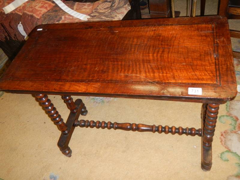 An early 20th century side table with bobbin turned legs and stretcher.