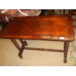 An early 20th century side table with bobbin turned legs and stretcher.