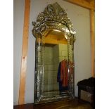 A large engraved gypsy style mirror.