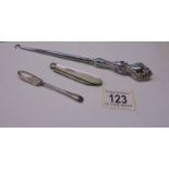 A silver pen knife, a silver jam spoon and a silver handled button hook.