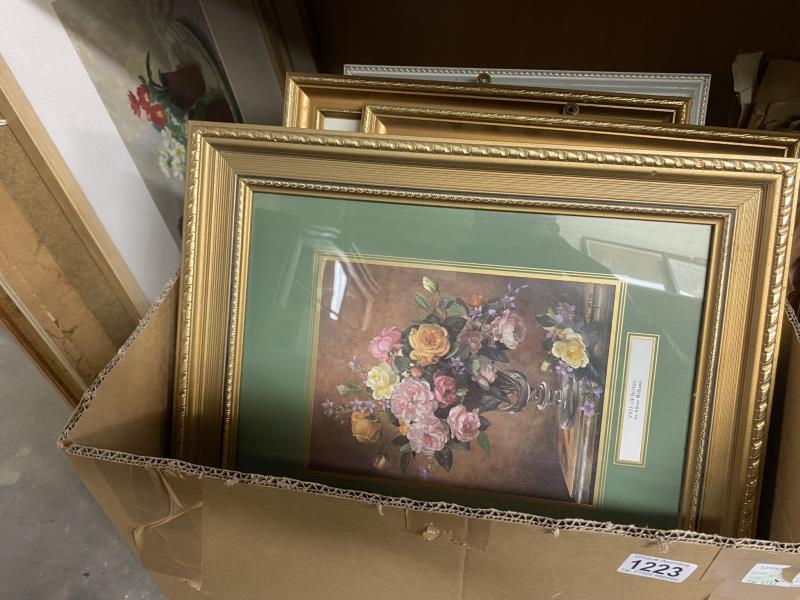 A box of various size picture frames with pictures