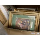 A box of various size picture frames with pictures