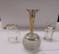 A silver spill vase, a matchstriker with silver rim and a glass pot with silver rim.