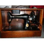 A cased Singer sewing machine.