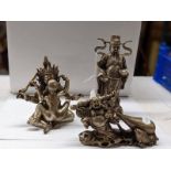 A Chinese erotic figure group and two Buddhas in metal.