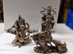 A Chinese erotic figure group and two Buddhas in metal.