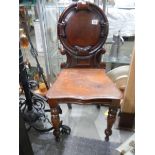 A Victorian mahogany hall chair.