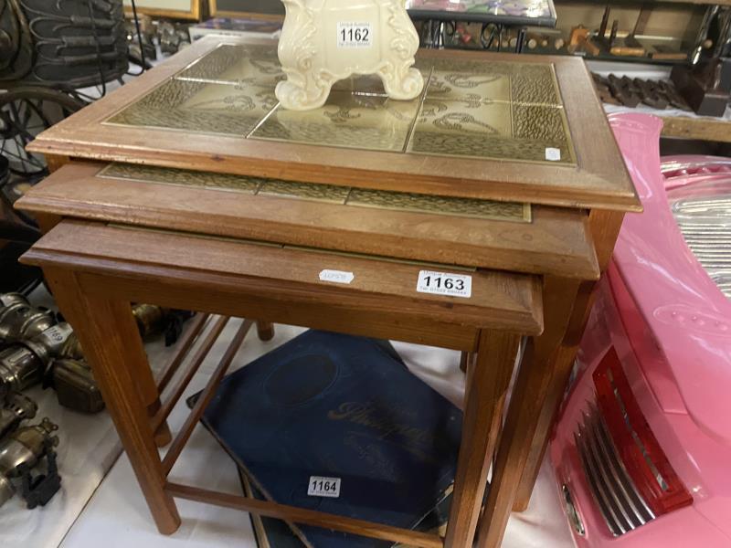 A vintage retro tile top teak nest of tables