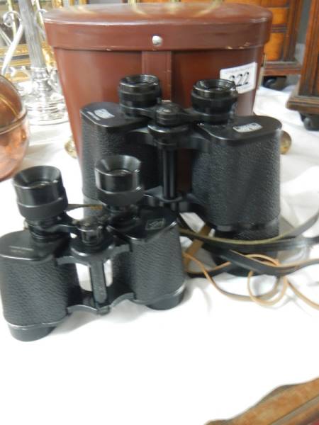 A cased pair of Carl Zeiss binoculars and a pair of Delacroix Paris binoculars.