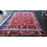 A large red patterned carpet - 330cm x 240cm (COLLECT ONLY)