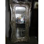 A large mirror in silvered frame, 180 x 90 cm.