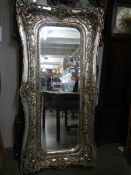 A large mirror in silvered frame, 180 x 90 cm.