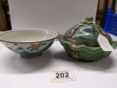 A Chinese lidded tea bowl with metal fittings and another Chinese tea bowl.