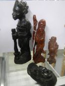 Three carved wood figures and a mask.