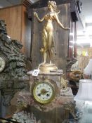 A French marble clock surmounted figure.