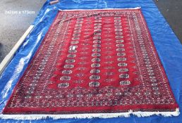 A large red patterned carpet - 247cm x 173cm (COLLECT ONLY)