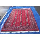 A large red patterned carpet - 247cm x 173cm (COLLECT ONLY)