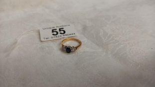 A diamond and sapphire three stone ring, stamped 18ct platinum, size L, 2.6 grams.