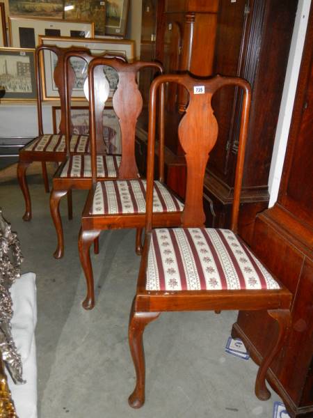 A set of four high back mahogany dining chairs.