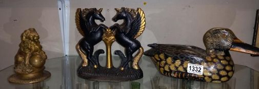 A cast iron Unicorn door stop & gilded lion & heavy cast iron duck