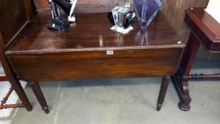 An Edwardian mahogany Pembroke table on turned legs COLLECT ONLY.
