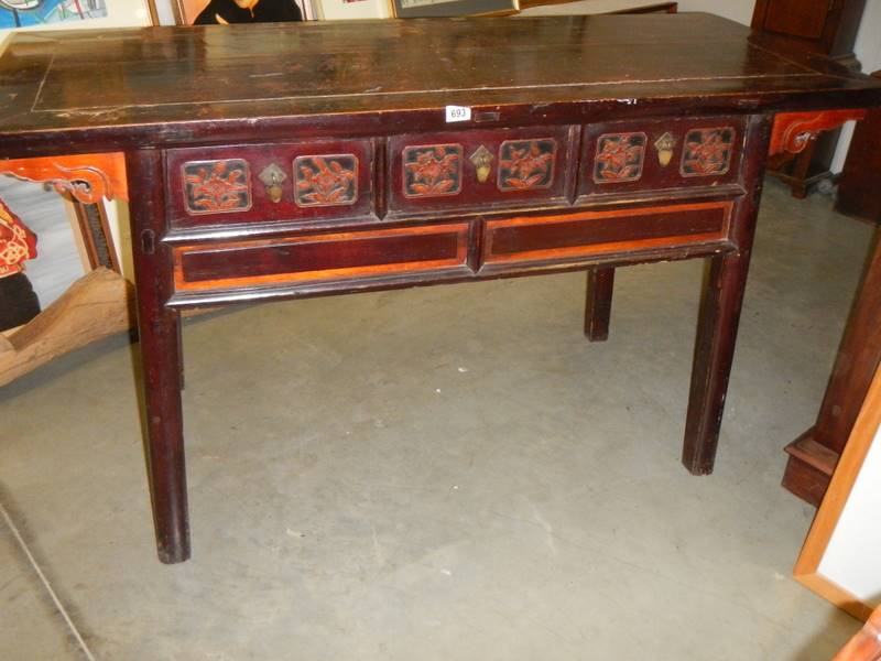 A Chinese carved three drawer hall table.