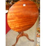 A circular mahogany tip top table. COLLECT ONLY.