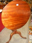 A circular mahogany tip top table. COLLECT ONLY.