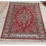 A reddish colour patterned rug - 46 inches x 66 inches (COLLECT ONLY)
