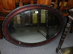 An oak framed bevel edged mirror, COLLECT ONLY.