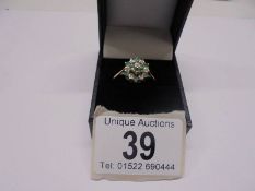 A floral emerald and diamond ring in yellow gold, size Z, 2.4 grams.