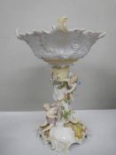 A porcelain table centrepiece featuring cherubs.