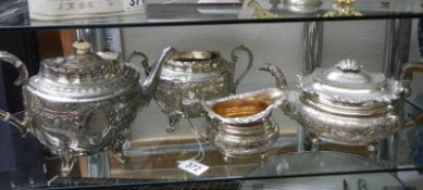 Two silver plate teapots. a milk jug and a sugar bowl.