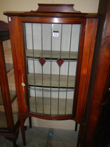 A mahogany inlaid single door display cabinet.