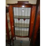 A mahogany inlaid single door display cabinet.